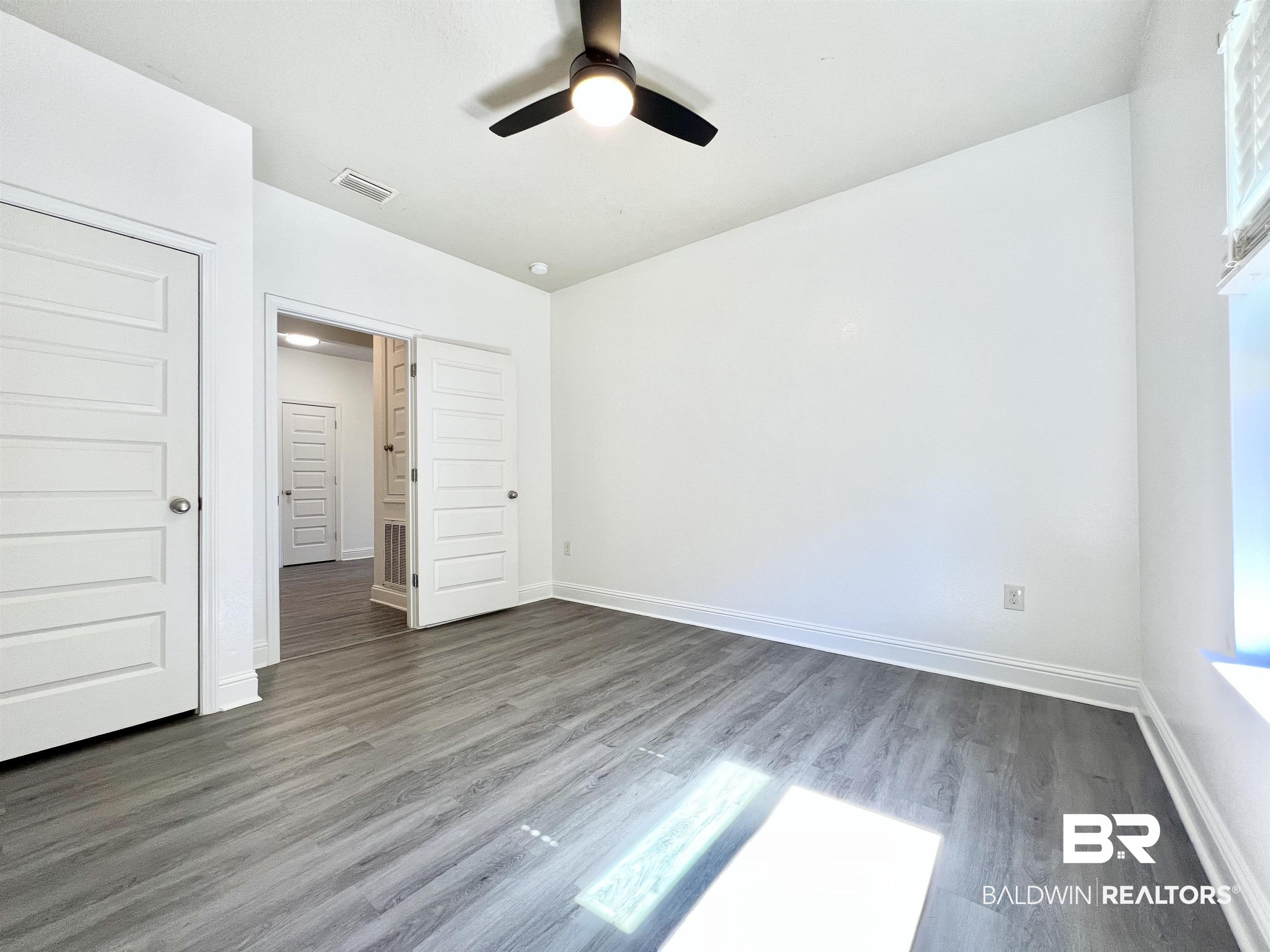 24785 Slater Mill Road Daphne, AL 36526 - Photo 23 of 46 Unfurnished bedroom with a closet, ceiling fan, and hardwood / wood-style floors