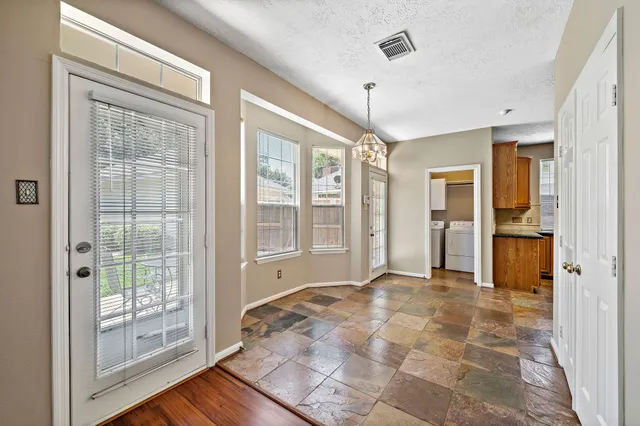a view of an empty room with glass door