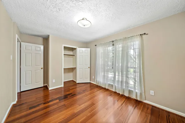 a bathroom with a granite countertop sink a toilet a shower and a mirror