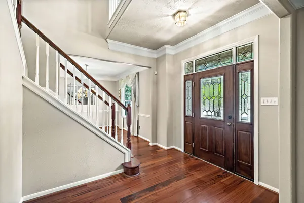 a view of an entryway with wooden floor and windows