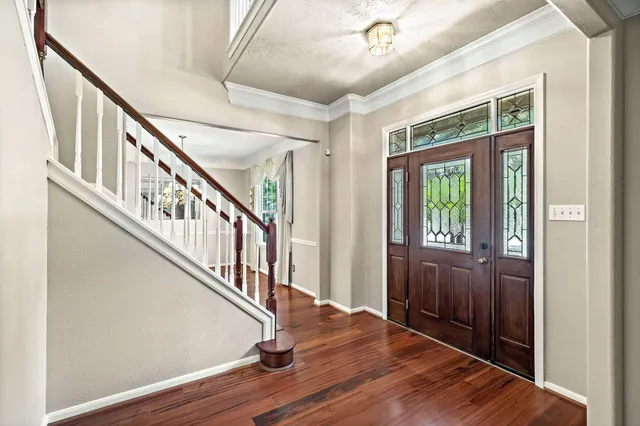 a view of an entryway with wooden floor and windows