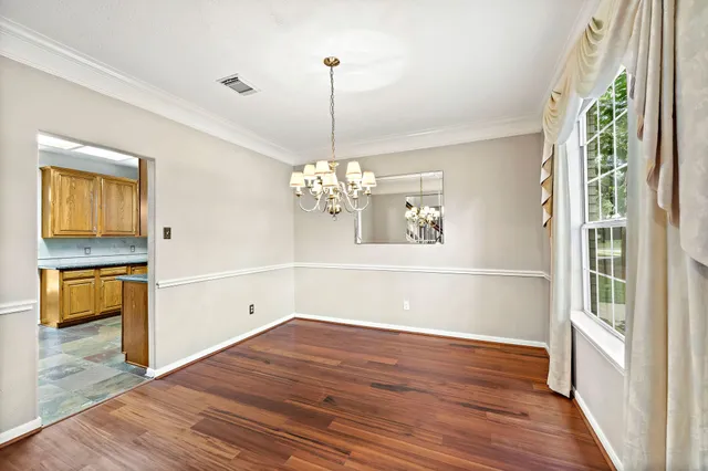 a view of a room with wooden floor and a window