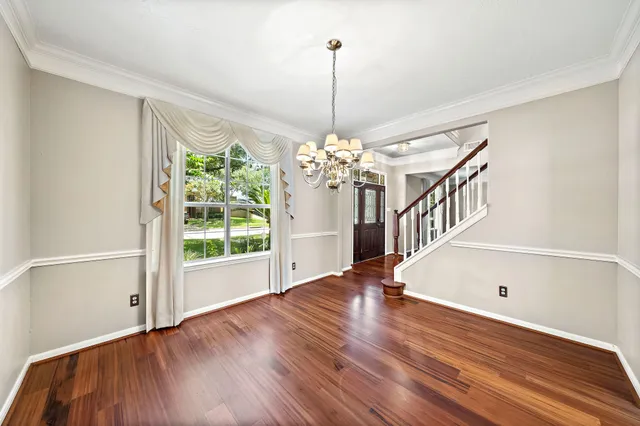a view of a room with wooden floor portable swimming pool and windows