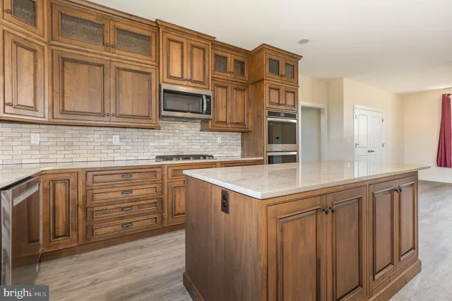 a kitchen with stainless steel appliances granite countertop a sink and cabinets