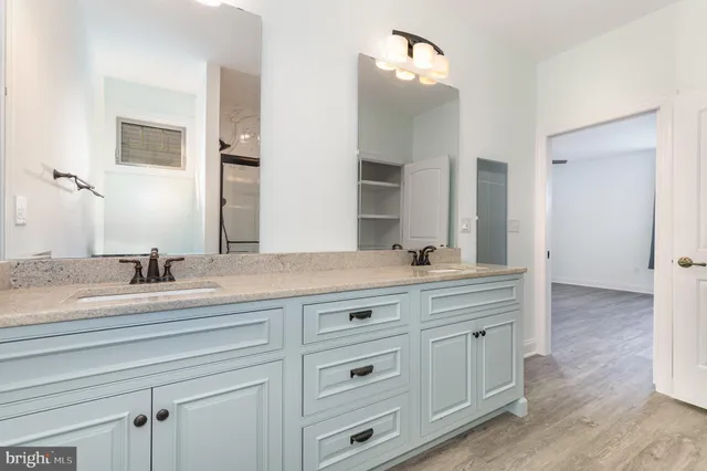 a spacious bathroom with double sink and a mirror