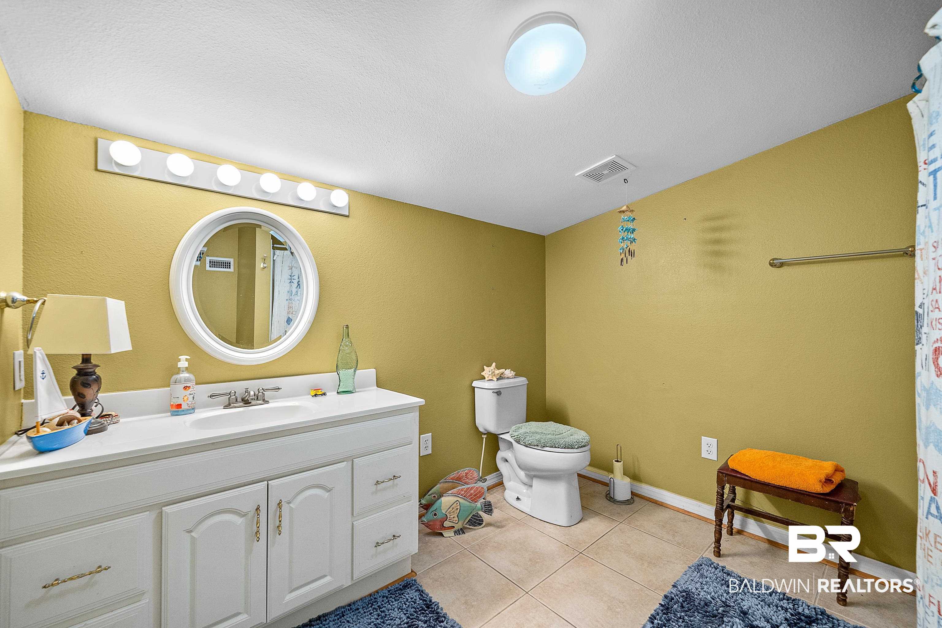 11528 Whitehouse Fork Road Bay Minette, AL 36507 - Photo 24 of 37 Full bath featuring light tile patterned floors, vanity, a shower with shower curtain, and a textured ceiling