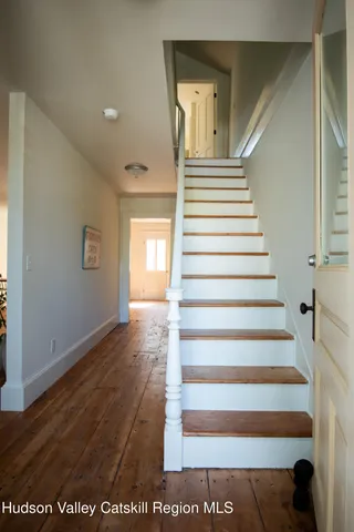 a view of entryway and hall with wooden floor