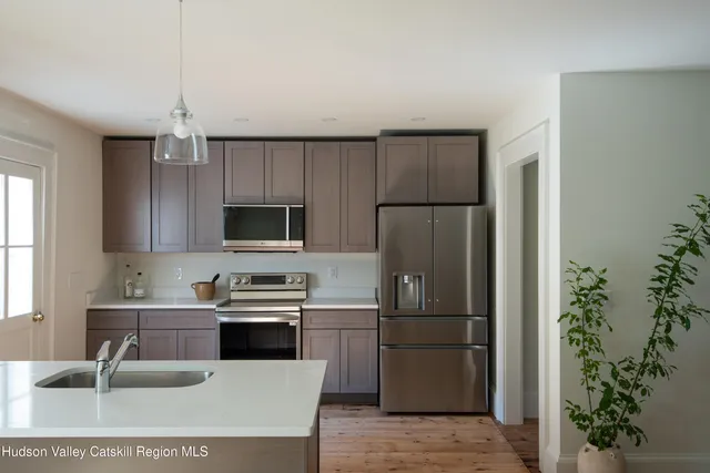 a kitchen with kitchen island a sink stainless steel appliances and cabinets
