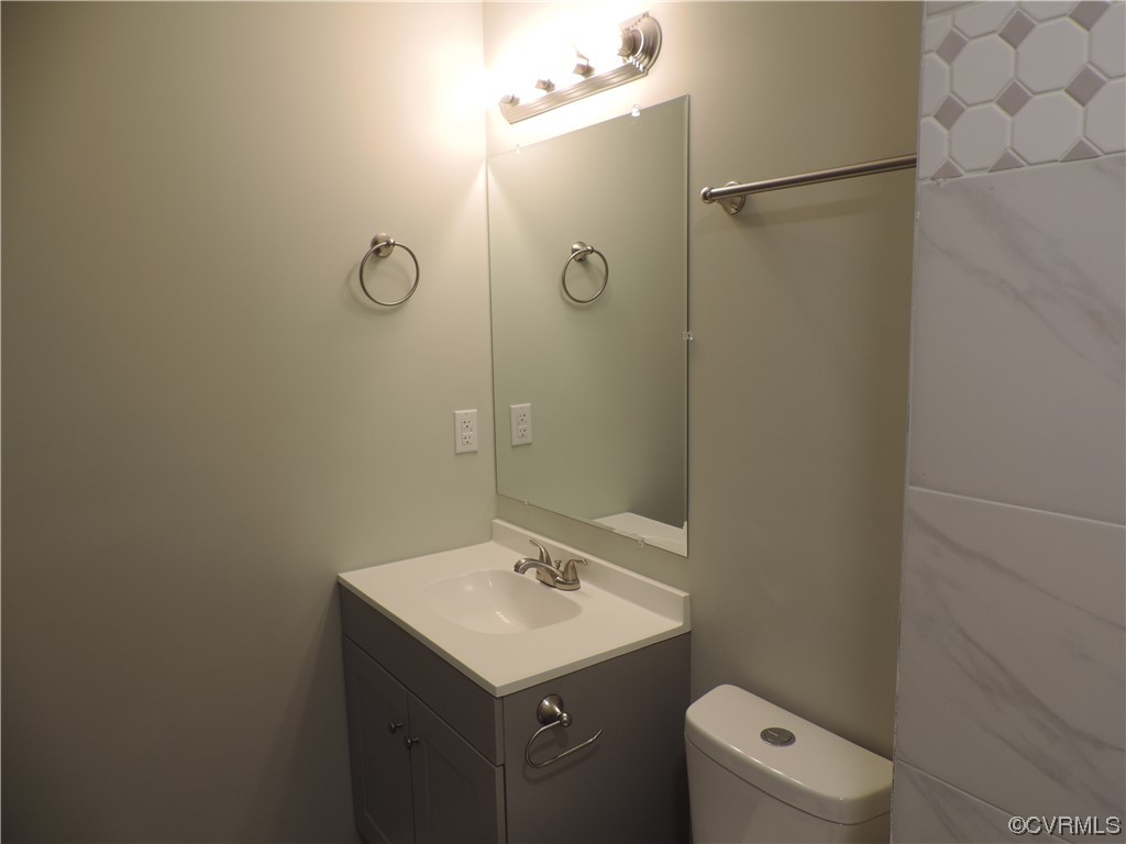9316 Becar Road North Chesterfield, VA 23236 - Photo 17 of 32 a bathroom with a sink a toilet and shower