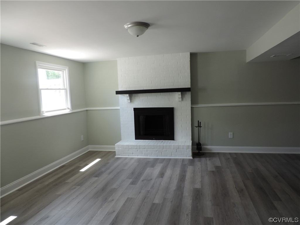 9316 Becar Road North Chesterfield, VA 23236 - Photo 20 of 32 an empty room with wooden floor fireplace and windows