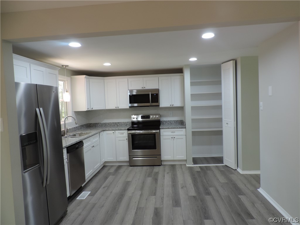 9316 Becar Road North Chesterfield, VA 23236 - Photo 3 of 32 a kitchen with granite countertop a refrigerator and a stove top oven