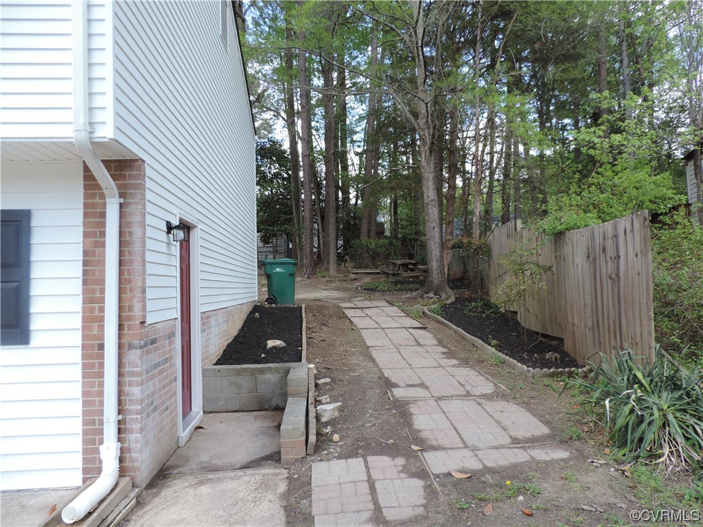 9316 Becar Road North Chesterfield, VA 23236 - Photo 32 of 32 a view of a patio with table and chairs with wooden fence and plants