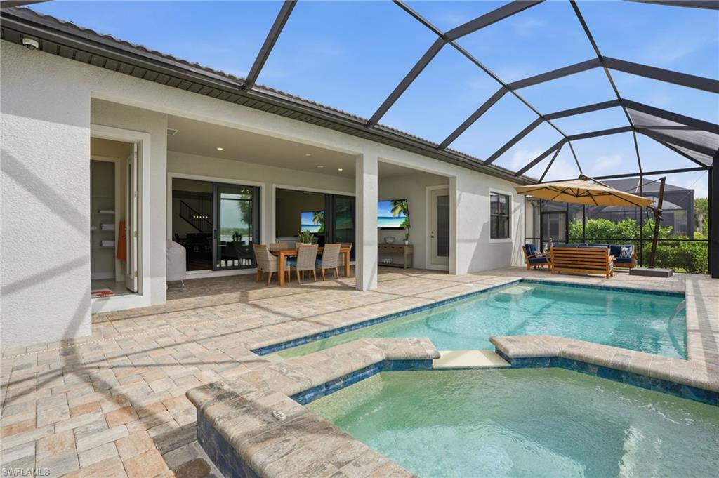 19696 Aqua View Lane Fort Myers, FL 33913 - Photo 35 of 50 a view of a patio with table and chairs under an umbrella