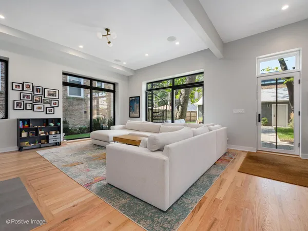 a living room with furniture and large windows