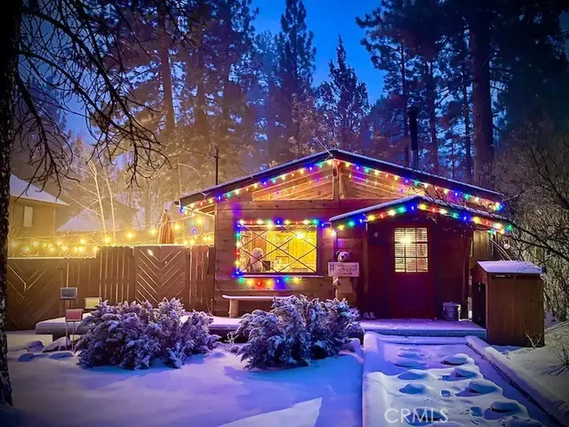 a sign that is sitting in front of yellow house