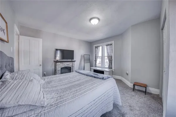 a bedroom with a bed and a tv