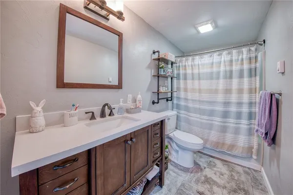 a bathroom with a double vanity sink toilet and shower
