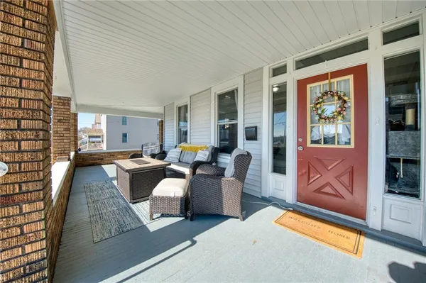 a living room with furniture and large windows