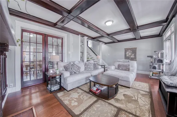a living room with furniture and a floor to ceiling window