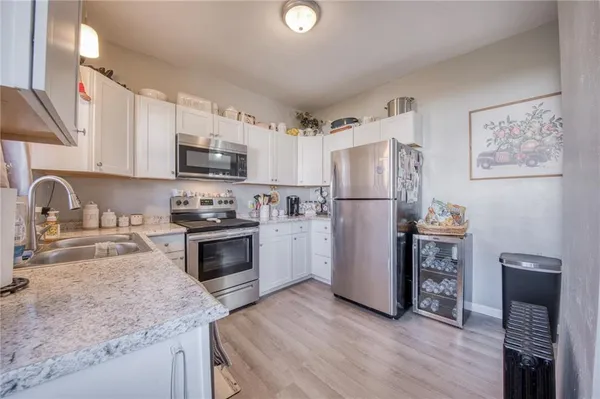 a kitchen with a refrigerator stove and sink