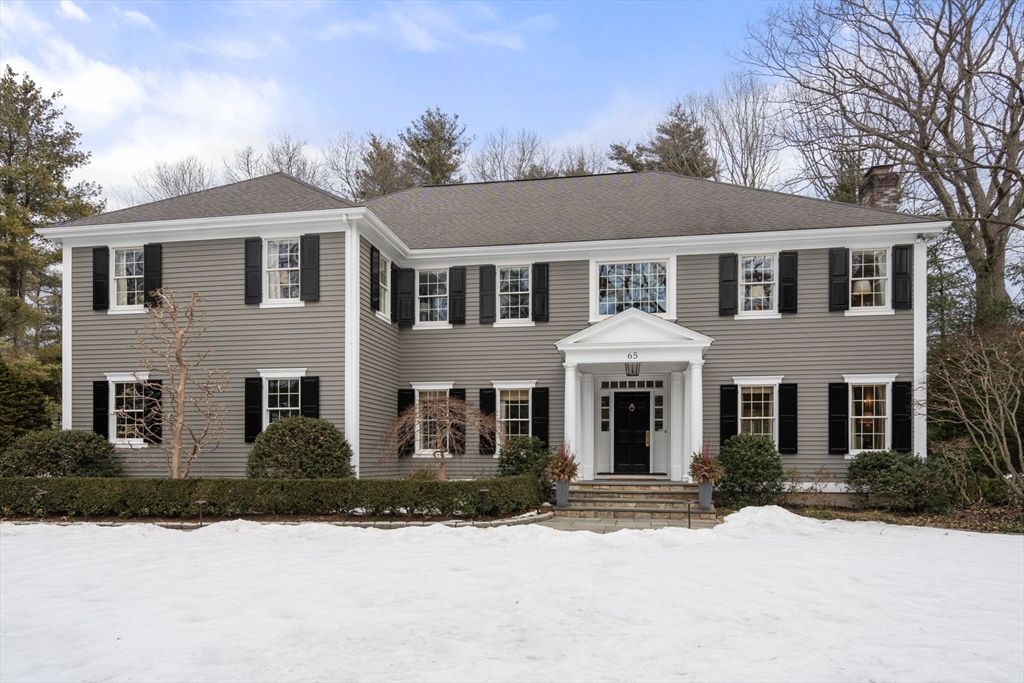 65 Colchester Road Weston, MA 02493 - Photo 1 of 1 a front view of a house with yard and trees