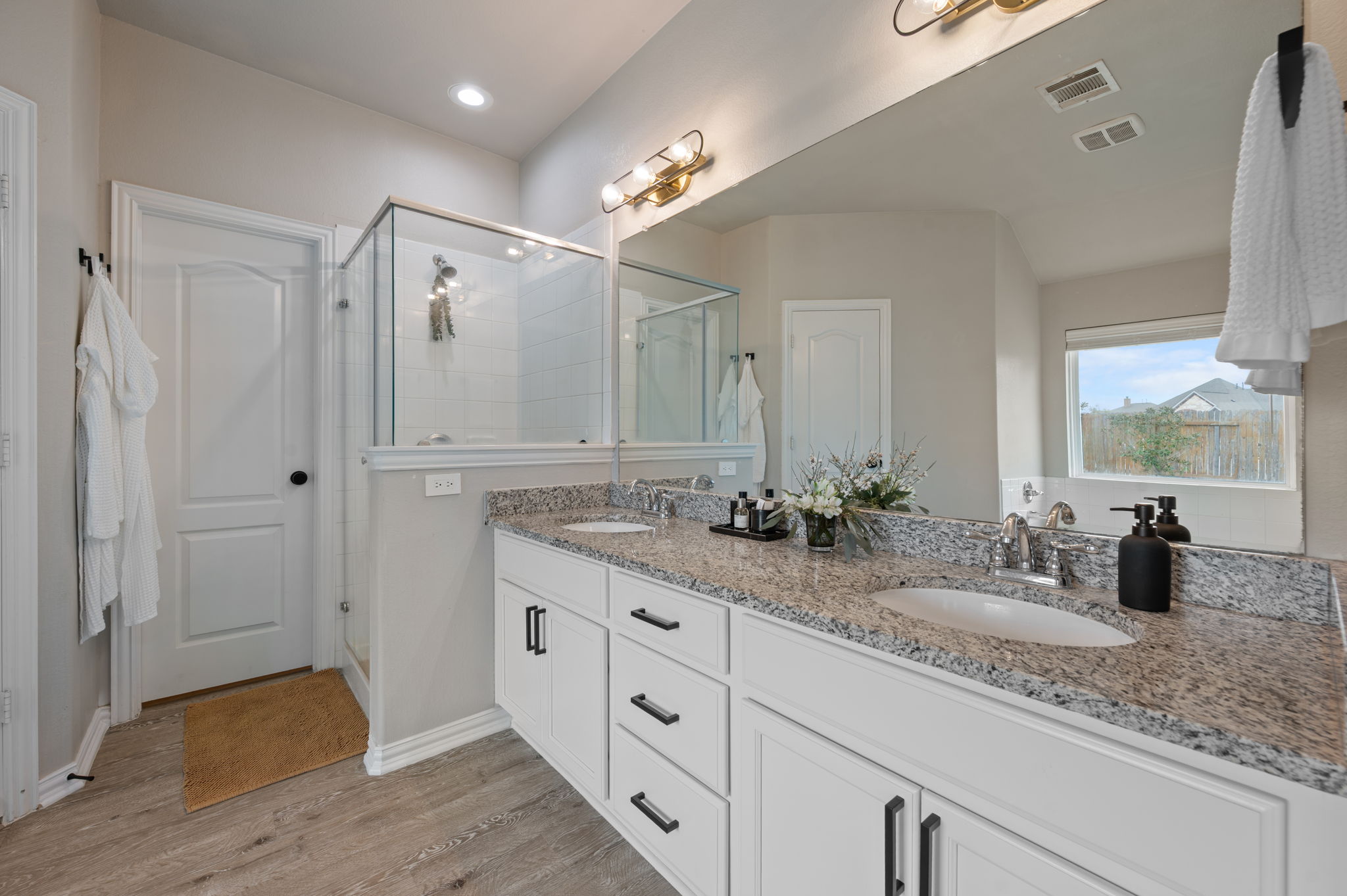 3724 Brean Down Road Pflugerville, TX 78660 - Photo 14 of 34 a bathroom with double vanity and a mirror