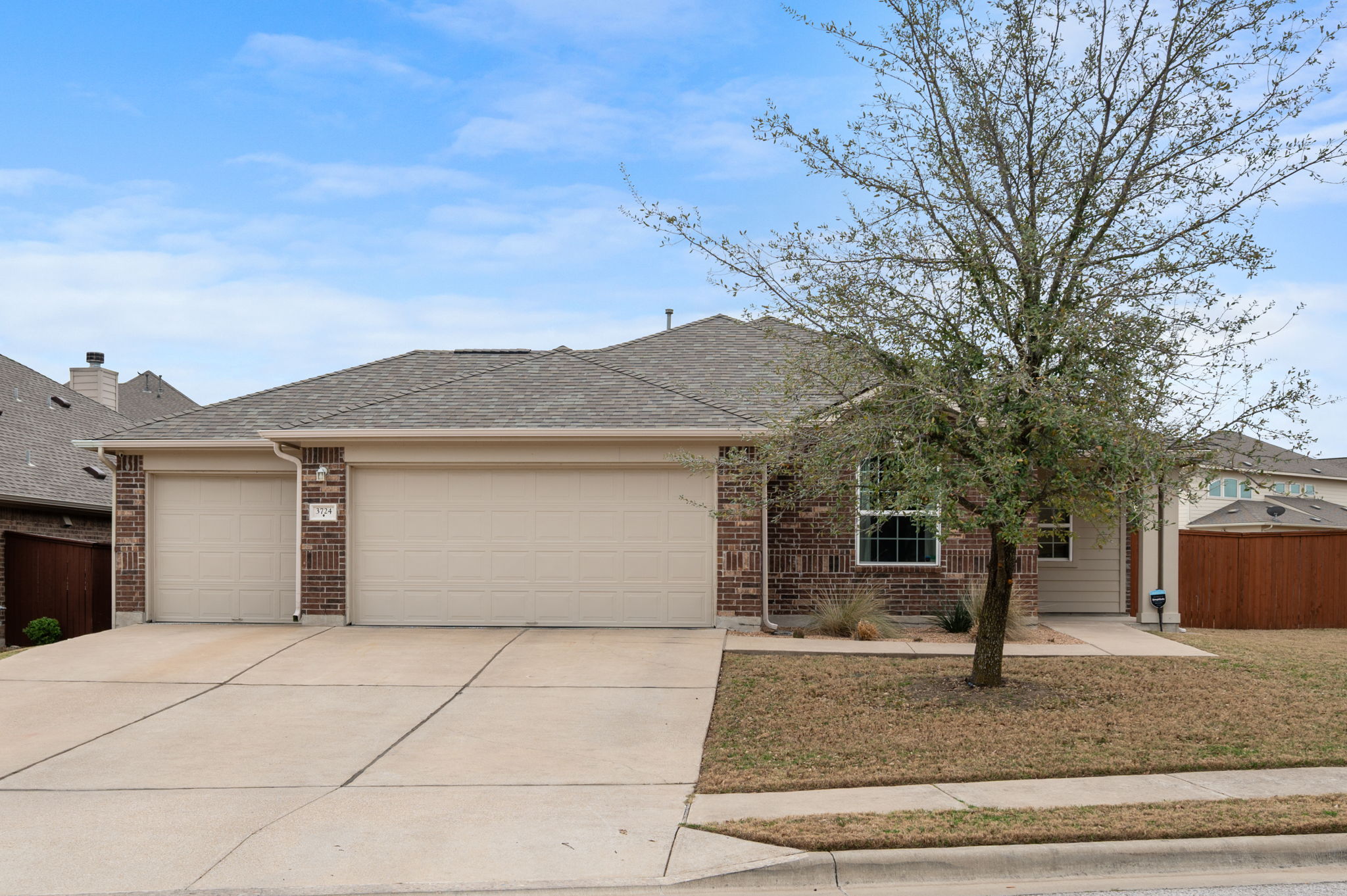 3724 Brean Down Road Pflugerville, TX 78660 - Photo 2 of 34 a front view of house with yard garage and trees