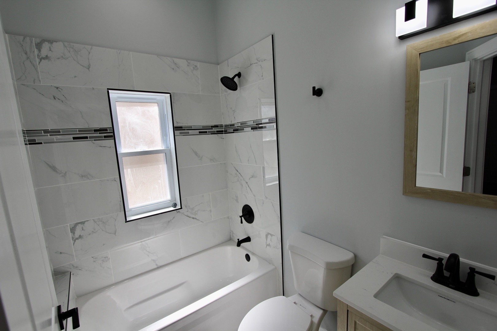 7413 South Princeton Avenue, Unit 1 Chicago, IL 60621 - Photo 12 of 24 a bathroom with a bathtub a toilet and a sink