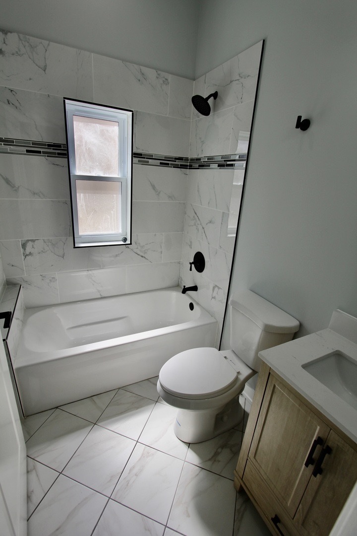 7413 South Princeton Avenue, Unit 1 Chicago, IL 60621 - Photo 13 of 24 a bathroom with a sink toilet and shower