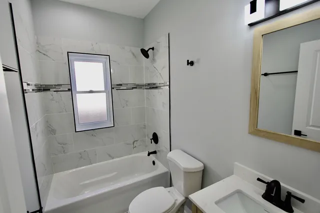 a bathroom with a toilet and a bathtub