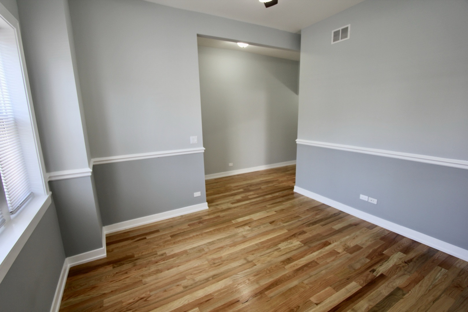 7413 South Princeton Avenue, Unit 1 Chicago, IL 60621 - Photo 5 of 24 a view of an empty room with wooden floor