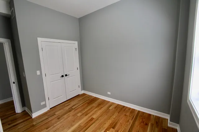 a view of room with wooden floor