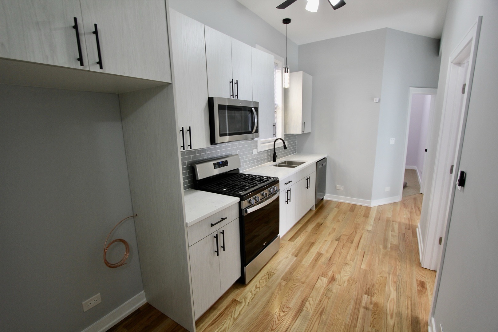 7413 South Princeton Avenue, Unit 1 Chicago, IL 60621 - Photo 7 of 24 a kitchen with cabinets a sink and appliances