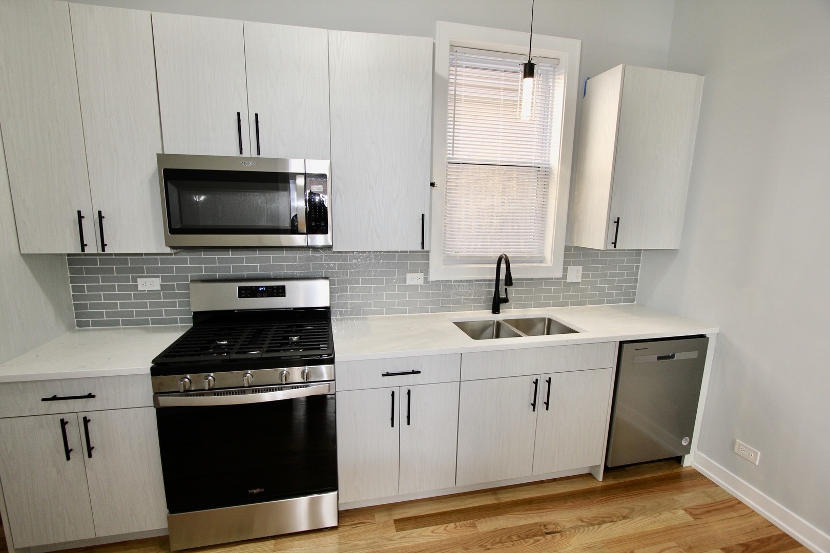 7413 South Princeton Avenue, Unit 1 Chicago, IL 60621 - Photo 8 of 24 a kitchen with cabinets appliances a sink and a counter top