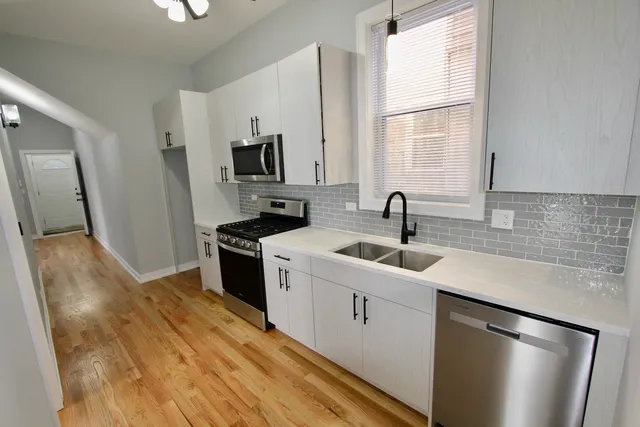 a kitchen with a sink stove and refrigerator
