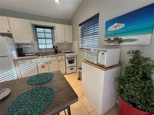 a kitchen with stainless steel appliances granite countertop a stove a sink dishwasher and cabinets