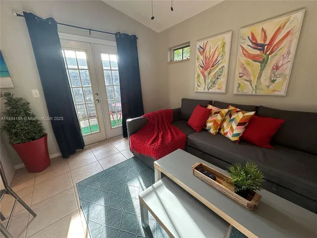 a living room with furniture and a potted plant