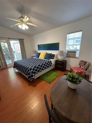 a bedroom with a bed table and window