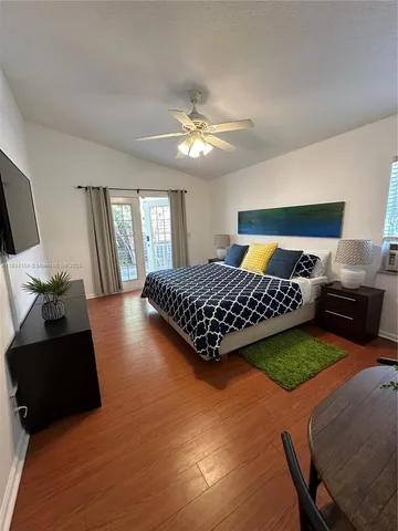 a bedroom with a bed furniture and a large window