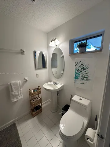 a bathroom with a toilet a sink and a mirror