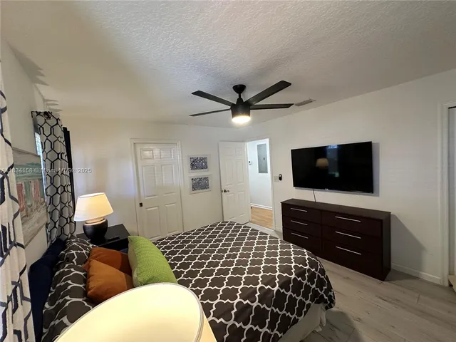 a bedroom with a bed and a television