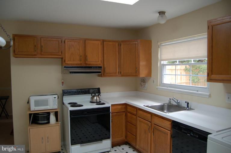 2016 Derrickson Road Windsor Mill, MD 21244 - Photo 2 of 11 a kitchen with a sink stove and cabinets