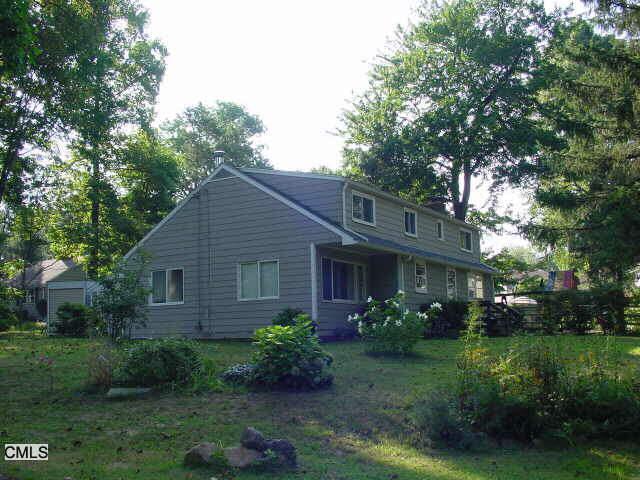 a view of a house with a yard and plants
