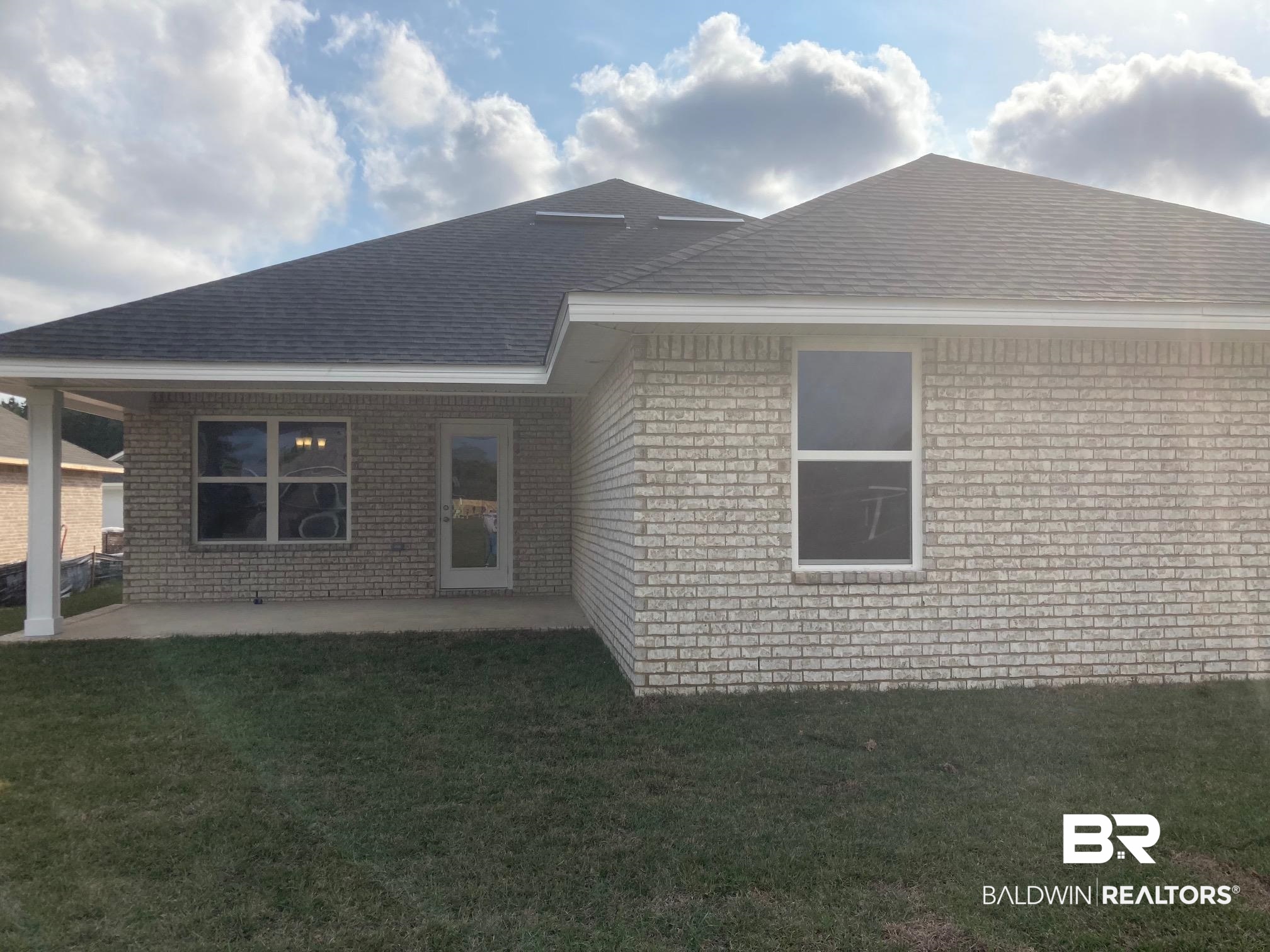 629 Revere Street Foley, AL 36535 - Photo 25 of 30 Back of property featuring a patio area and a yard