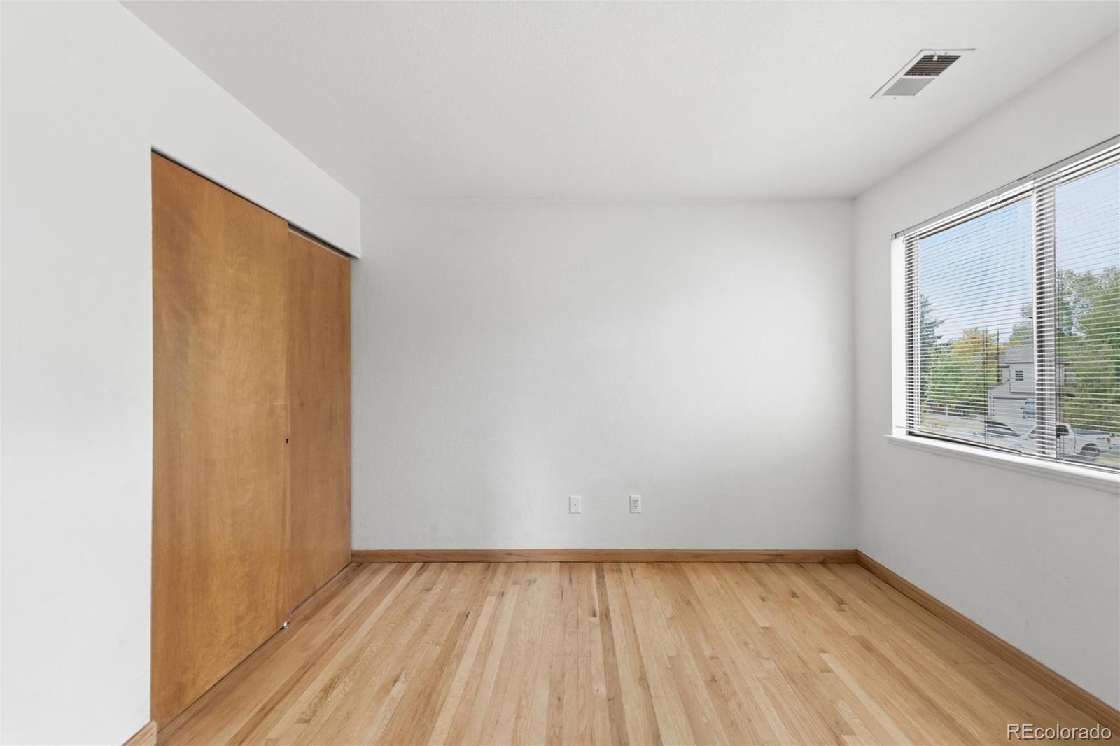 5510 Stonewall Place, Unit 24 Boulder, CO 80303 - Photo 24 of 30 a view of an empty room with wooden floor and a window