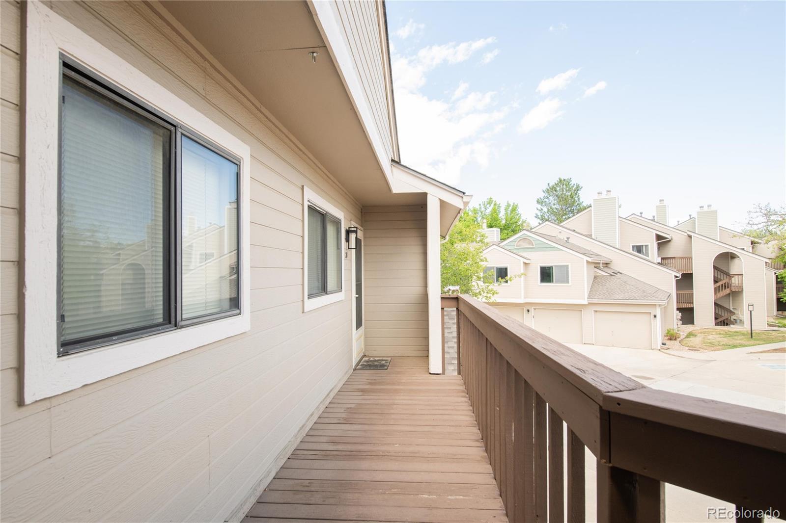 5510 Stonewall Place, Unit 24 Boulder, CO 80303 - Photo 29 of 30 a view of a balcony with wooden floor and fence