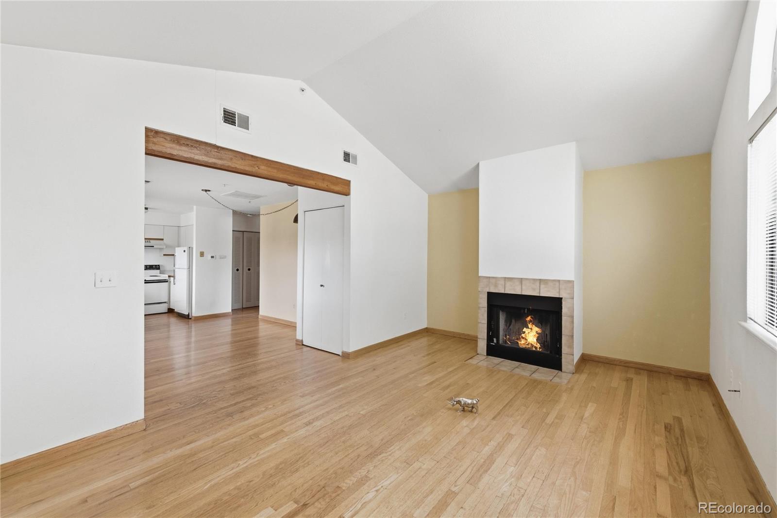 5510 Stonewall Place, Unit 24 Boulder, CO 80303 - Photo 6 of 30 a view of an empty room with wooden floor fireplace and a window