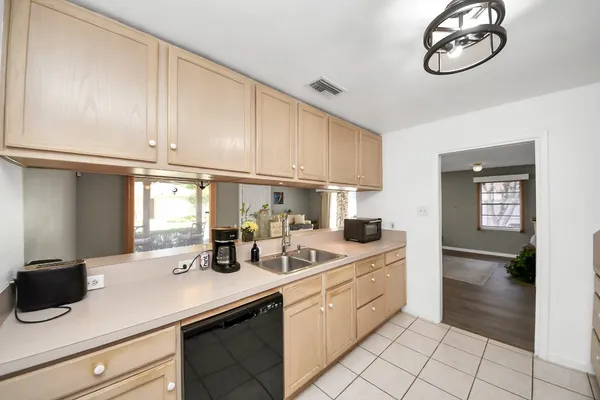 a kitchen with white cabinets and white appliances