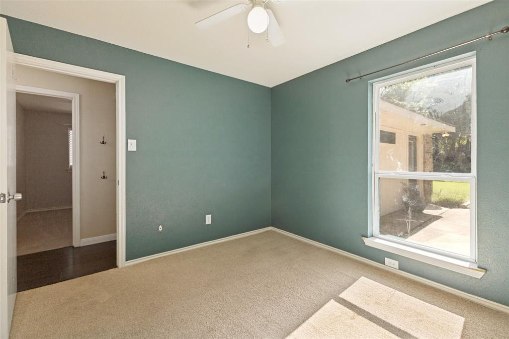 3010 Rambling Drive Dallas, TX 75228 - Photo 18 of 25 Carpeted room with a ceiling fan, a window, and a white door frame