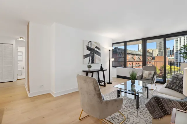 a living room with furniture and large window